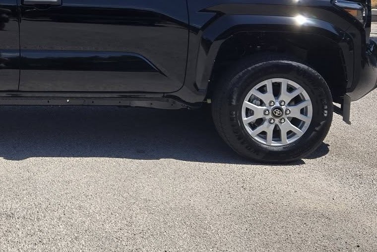 Front wheel and fender of the new black Toyota Tacoma